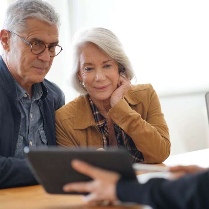 Independent living cost in Georgia Older adult couple looking at a tablet
