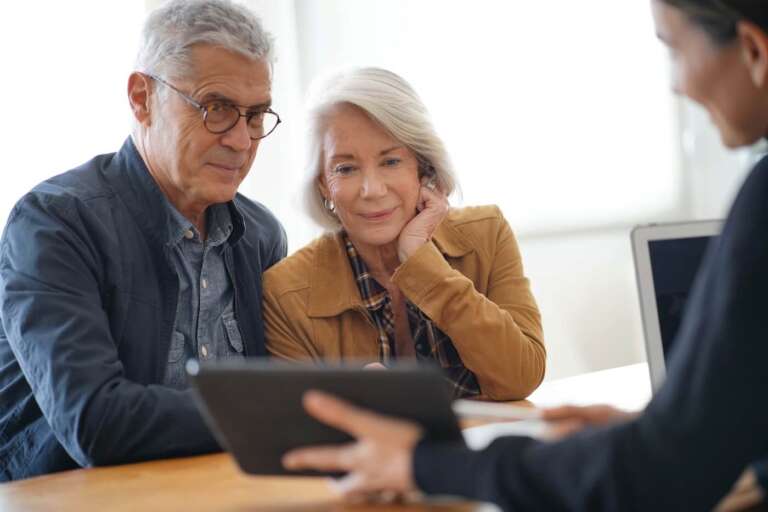 Independent living cost in Georgia Older adult couple looking at a tablet