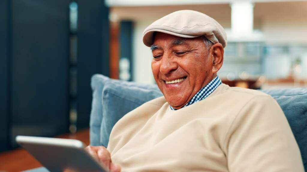 Planning Ahead for Independent Living smiling senior lviing resident looking at tablet