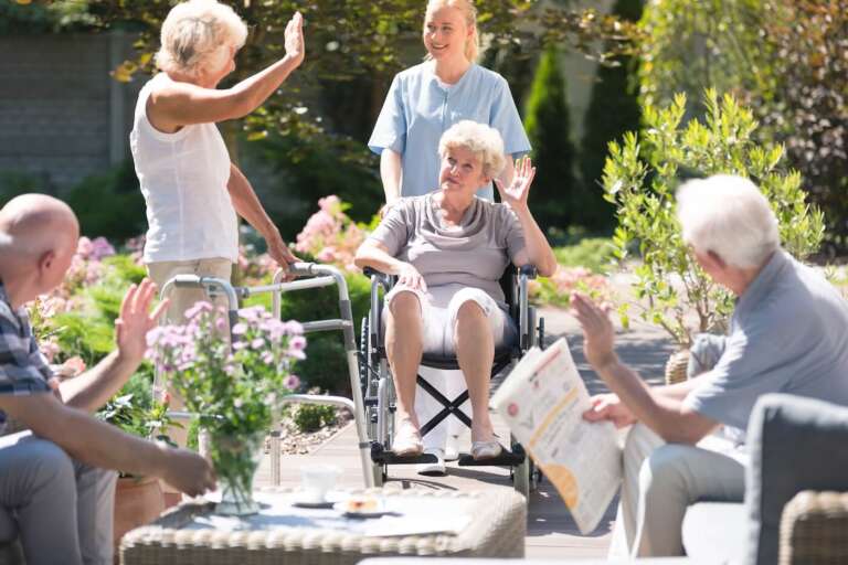transitional care residents outside on the patio in sun