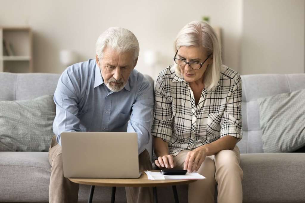 seniors looking at computer researching is independent living cheaper than keeping the house