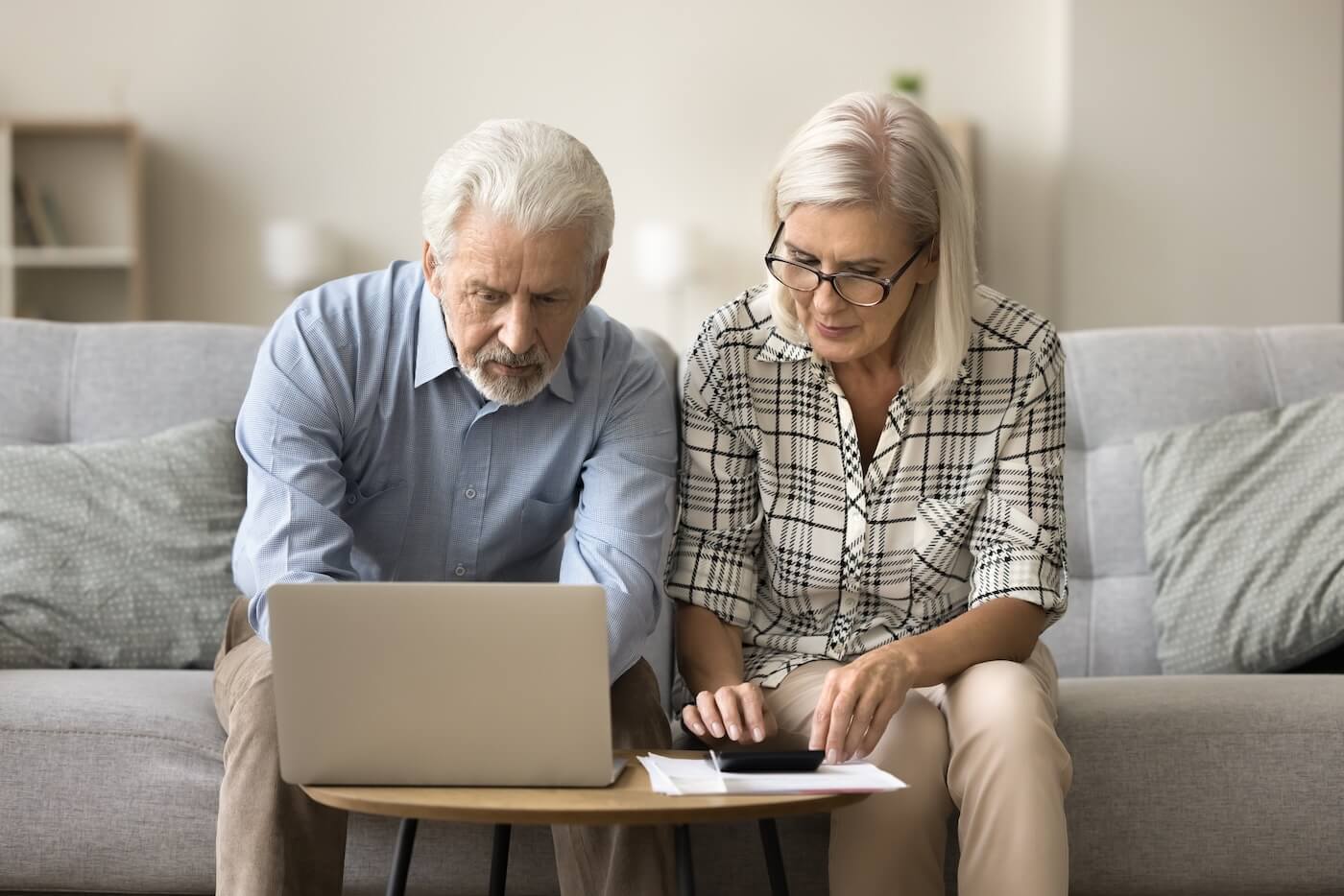 seniors looking at computer researching is independent living cheaper than keeping the house