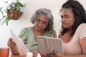 adult daughter and senior mom looking at care services pricing Bogart GA